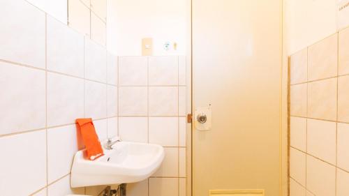 a white bathroom with a sink and a mirror at RedDoorz @ Ola Vida Casa Rental Ilocos Sur in Santa Catalina