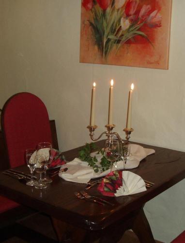 a table with three candles on top of it at Land-gut-Hotel BurgBlick in Bad Kreuznach