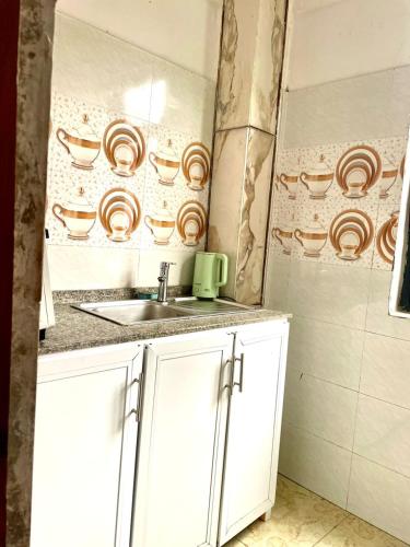a small kitchen with a sink and a counter at Gombe243 in Kinshasa