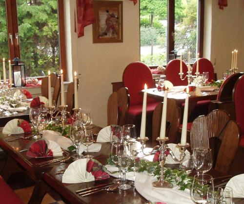 a dining room with tables and chairs with wine glasses at Land-gut-Hotel BurgBlick in Bad Kreuznach