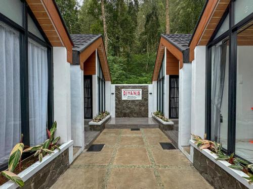 a row of houses with a sign that reads yawn at Diyanis Glamping Sekipan Tawangmangu Mitra RedDoorz in Tawangmangu
