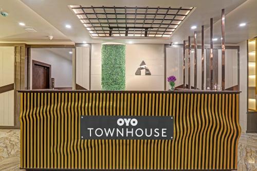 a view of a townhouse with a sign in a lobby at Townhouse Hotel Impact in Lucknow
