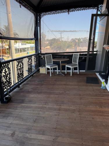 a porch with two chairs and a table on a balcony at The Loft Cobram Hotel in Cobram