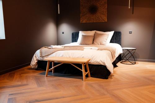 a bedroom with a bed and a wooden floor at Gite De La Borie in Saint-Ignat