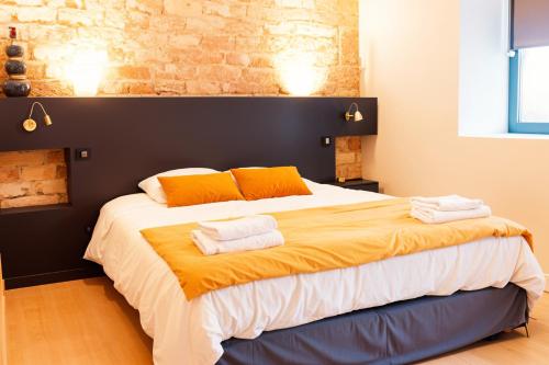 a bedroom with a large bed with two towels on it at Gite De La Borie in Saint-Ignat