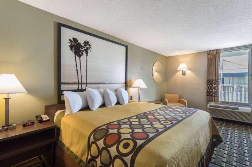 a hotel room with a large bed and a window at Super 8 by Wyndham Ocala I-75 in Ocala