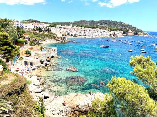 a view of a beach with boats in the water at CP 13-A - Calella de Palafrugell in Calella de Palafrugell