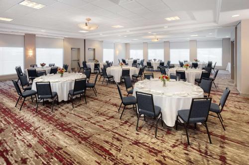 a banquet hall with white tables and chairs at Hilton Garden Inn Valley Forge/Oaks in Oaks
