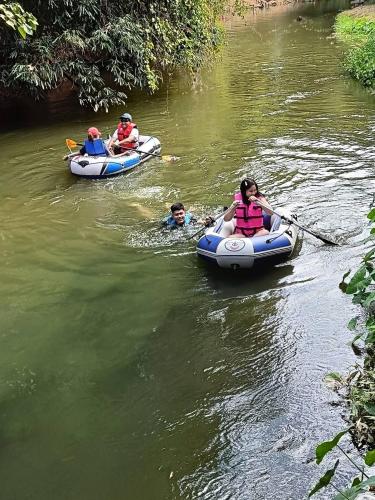 a group of people in canoes on a river at สวนเพื่อคุณ รีสอร์ทแอนด์แคมป์ปิ้ง in Ban Don Wan