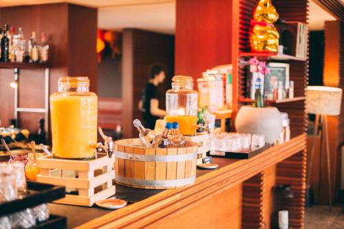 a counter with jars of orange juice on it at Me and All Hotel Dusseldorf, by Hyatt in Düsseldorf