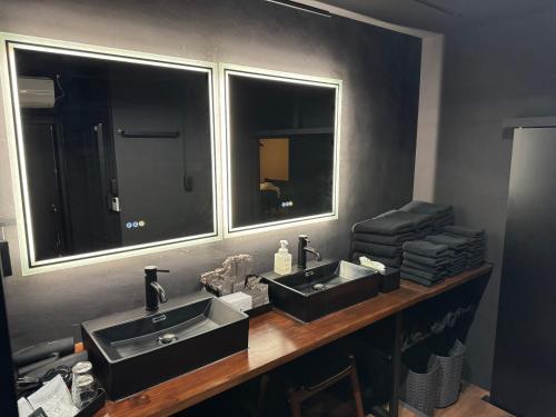 a bathroom with two sinks and a mirror at Black Villa Naha 最大8名宿泊可 136平米 美栄橋駅 徒歩1分 in Tomari