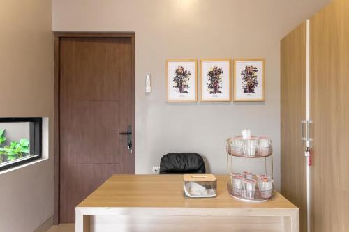 a room with a desk and a door and some pictures at Calma Jatimas Klayar Villa Sleman Jogja in Adi Sutjipto