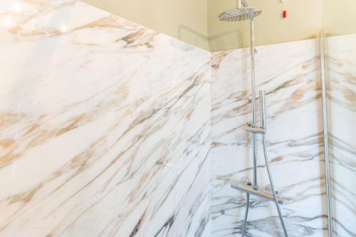 a white marble shower wall in a bathroom at La Rocca di Camporgiano in Camporgiano