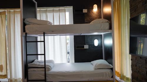 a couple of bunk beds in a room at Julley Commune Rishikesh in Rishīkesh
