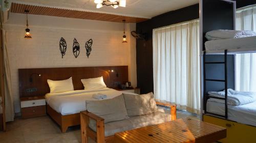 a bedroom with a bed and a bunk bed at Julley Commune Rishikesh in Rishīkesh