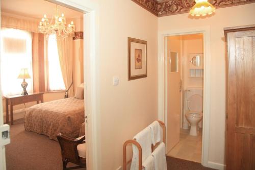 a bedroom with a bed and a bathroom at The Newark in Bournemouth