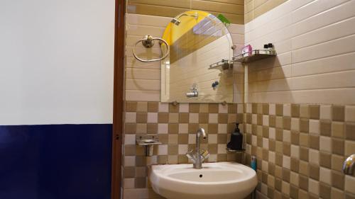 a bathroom with a sink and a mirror at Julley Commune Rishikesh in Rishīkesh