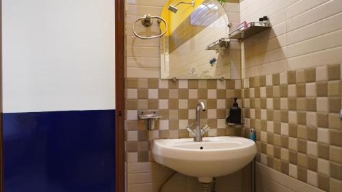a bathroom with a sink and a mirror at Julley Commune Rishikesh in Rishīkesh