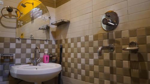 a bathroom with a sink and a mirror at Julley Commune Rishikesh in Rishīkesh