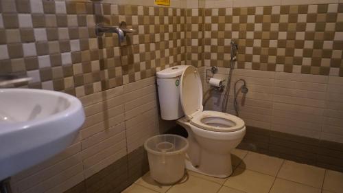a bathroom with a toilet and a sink at Julley Commune Rishikesh in Rishīkesh