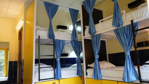 a room with bunk beds in a hostel at Julley Commune Rishikesh in Rishīkesh