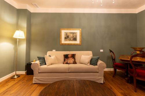 a living room with a couch with a dog on it at La Rocca di Camporgiano in Camporgiano