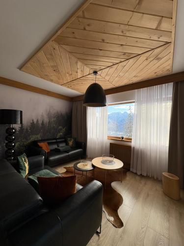 a living room with a couch and a table at Apartament SMRECEK na Pająkówce in Kościelisko