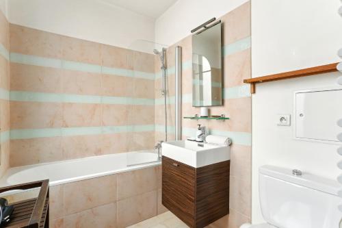une salle de bain avec un lavabo et une baignoire dans l'établissement Chic and comfortable studio near Paris, à Boulogne-Billancourt