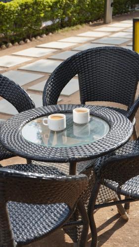 two cups of coffee sitting on a patio table at Julley Commune Rishikesh in Rishīkesh