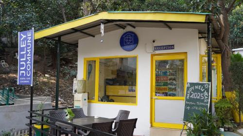 a restaurant with yellow doors and a table at Julley Commune Rishikesh in Rishīkesh