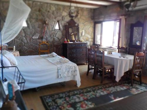 a bedroom with a bed and a table and chairs at Traditional house in Sigri in Sígrion