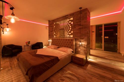 a bedroom with a bed in a room with a light at Vera HOTEL-VILLA in Pristina