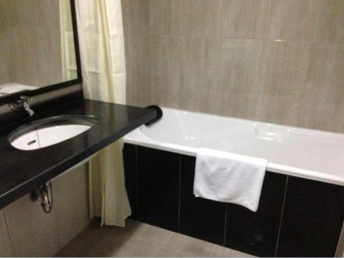 a bathroom with a sink and a bath tub at Safa Homestay in Yogyakarta