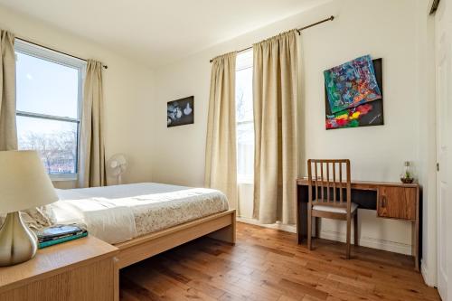 a bedroom with a bed and a desk and window at Apartment ROOMY - Plateau Mont-Royal in Montréal