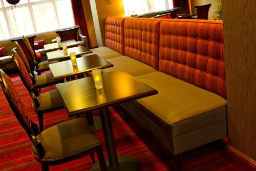 a row of tables and chairs in a restaurant at Holiday Inn Express Hotel & Suites Vineland Millville by IHG in Vineland