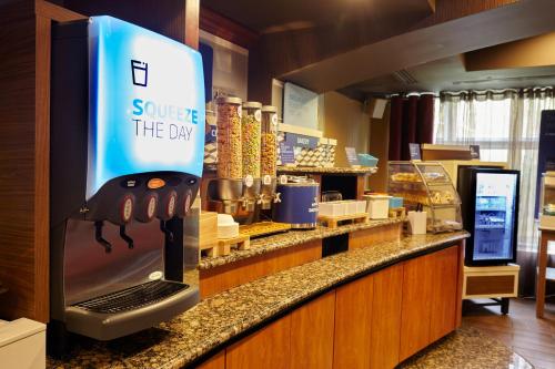 a store counter with a sign that says surprise the day at Holiday Inn Express Hotel & Suites Vineland Millville by IHG in Vineland