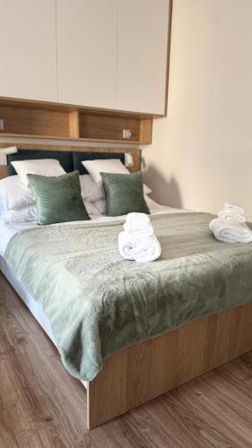 a bedroom with a large bed with towels on it at Nowa Huta 12 in Krakow