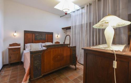a bedroom with a bed and a lamp on a dresser at 1 Bedroom Gorgeous Home In Mascalucia in Mascalucia