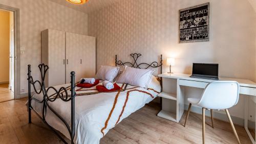 - une chambre avec un lit, un bureau et un ordinateur portable dans l'établissement Les Toits de Darcy - Dijon Centre historique, à Dijon