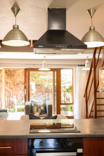 a kitchen with two lights and a stove top oven at Raptors Wildlife Escapes in Hoedspruit