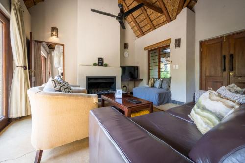 a living room with a couch and a table at Raptors Lodge in Hoedspruit