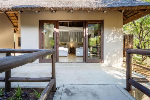 an open door to a house with a patio at Raptors Lodge in Hoedspruit
