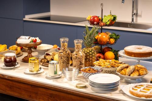 a table with a buffet of food and desserts at La Rocca di Camporgiano in Camporgiano