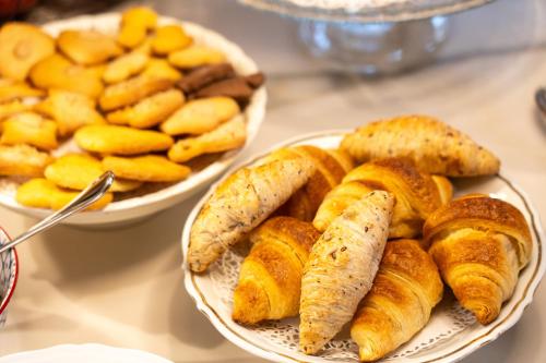 a table with two plates of pastries and a plate of bread at La Rocca di Camporgiano in Camporgiano