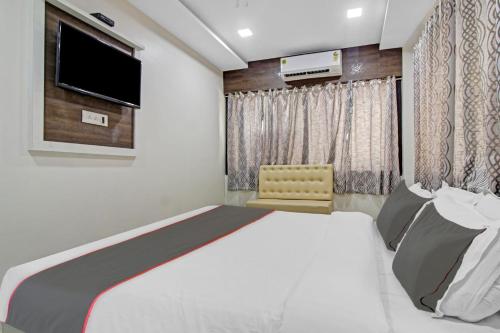 a bedroom with a large bed and a television at Hotel O Raj Mahal in Turambhe