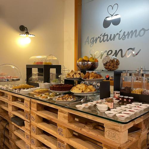 a buffet filled with different types of pastries and desserts at Agriturismo & Agricamping Serena in Pastrengo