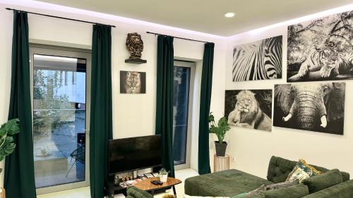 a living room with a green couch and pictures on the wall at African Paradise with Jacuzzi & Sauna in Vienna