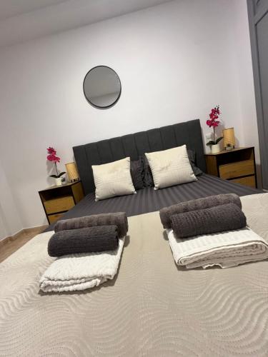 a bedroom with a large bed with pillows on it at Magdalena Apartament in Torrevieja
