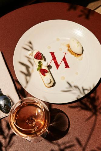 a white plate with food on a table at Hôtel & Spa Version Maquis Citadelle in Bonifacio