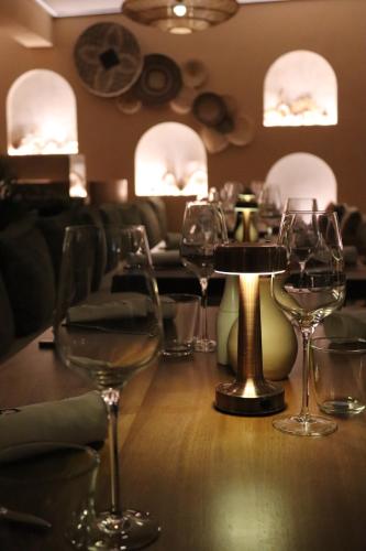 a group of wine glasses on a table in a restaurant at Hayat Sky Hotel Rust in Rust